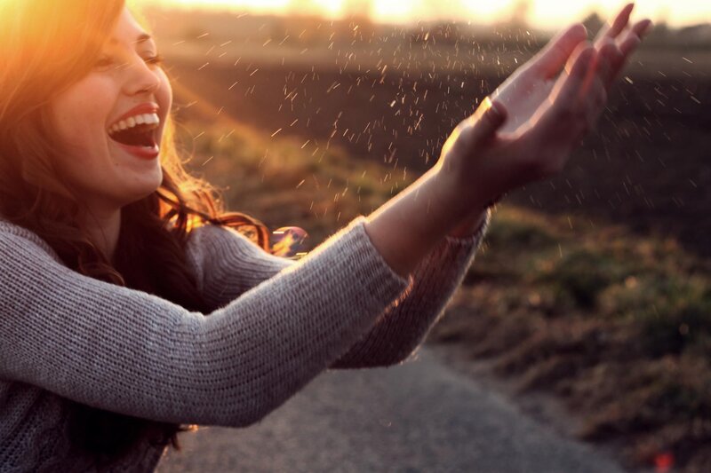 woman laughing at sunset
