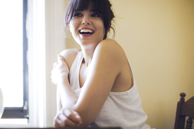 woman laughing by window