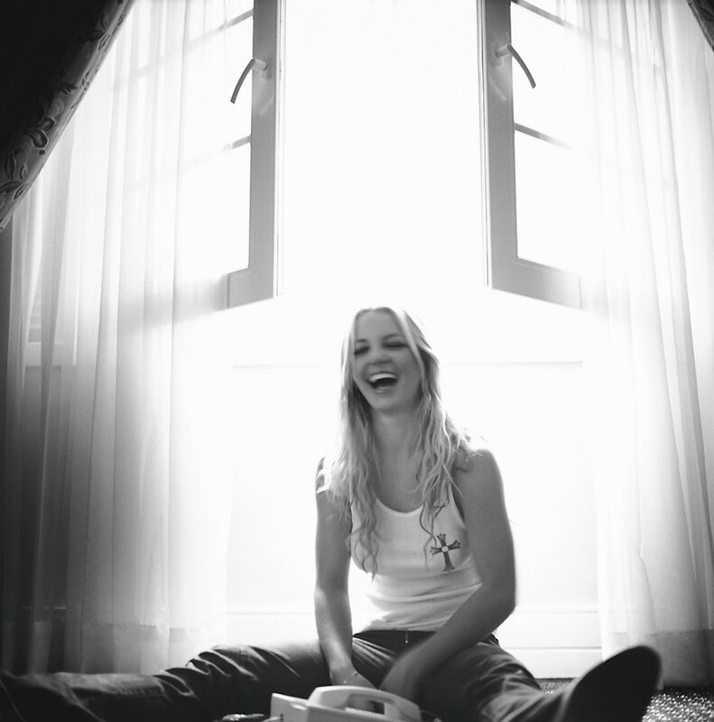 woman laughing by window