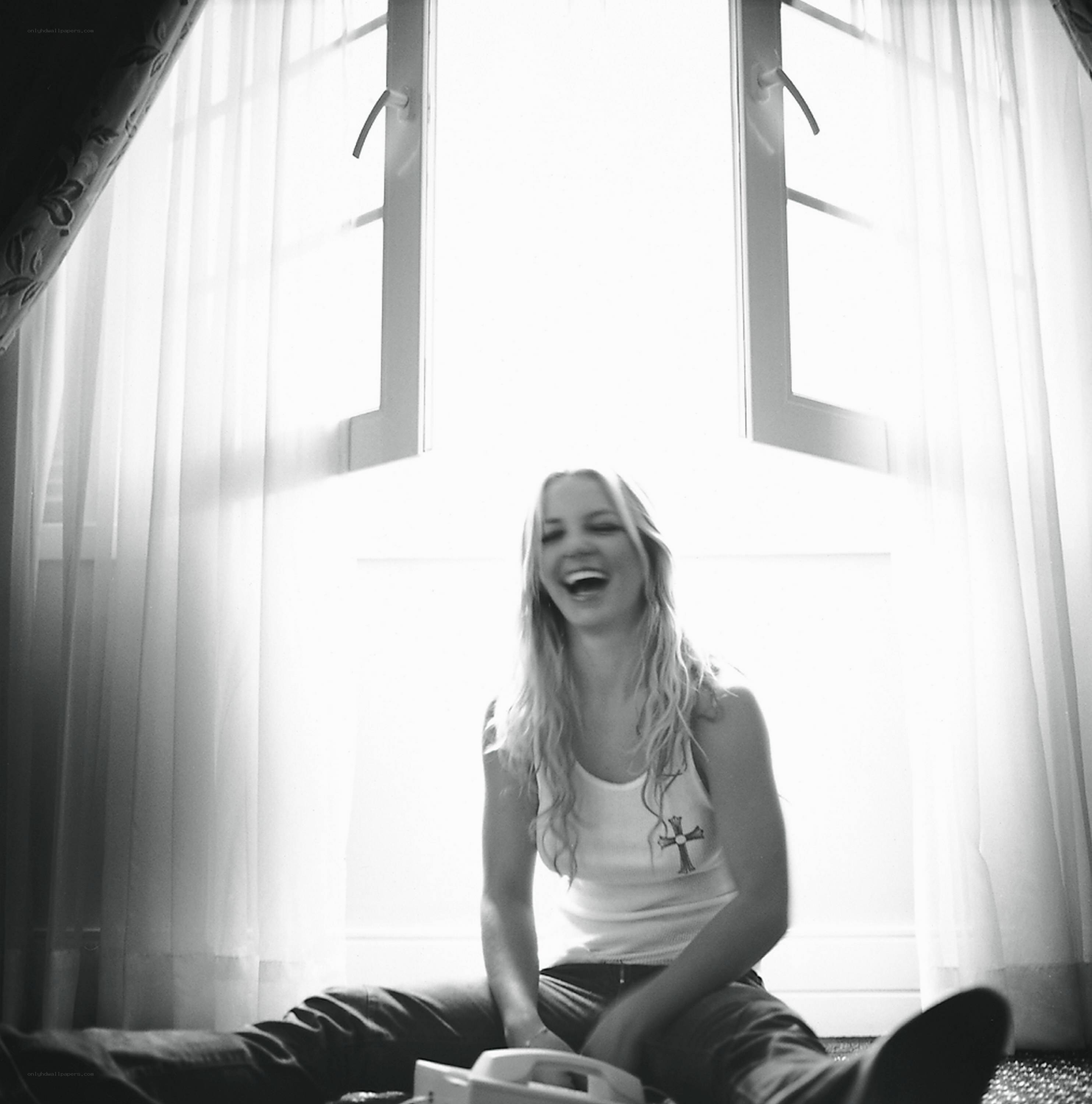 woman laughing by window