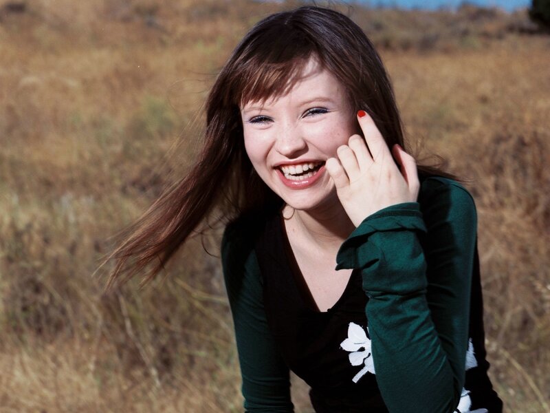 woman laughing in a field