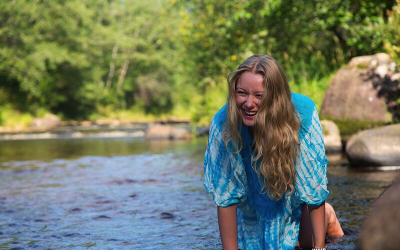 Woman laughing in a river
