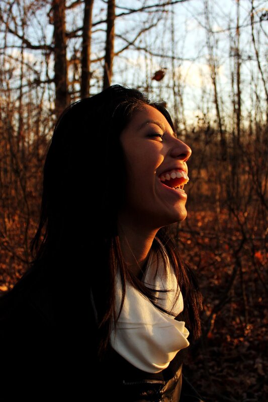 woman laughing in autumn forest