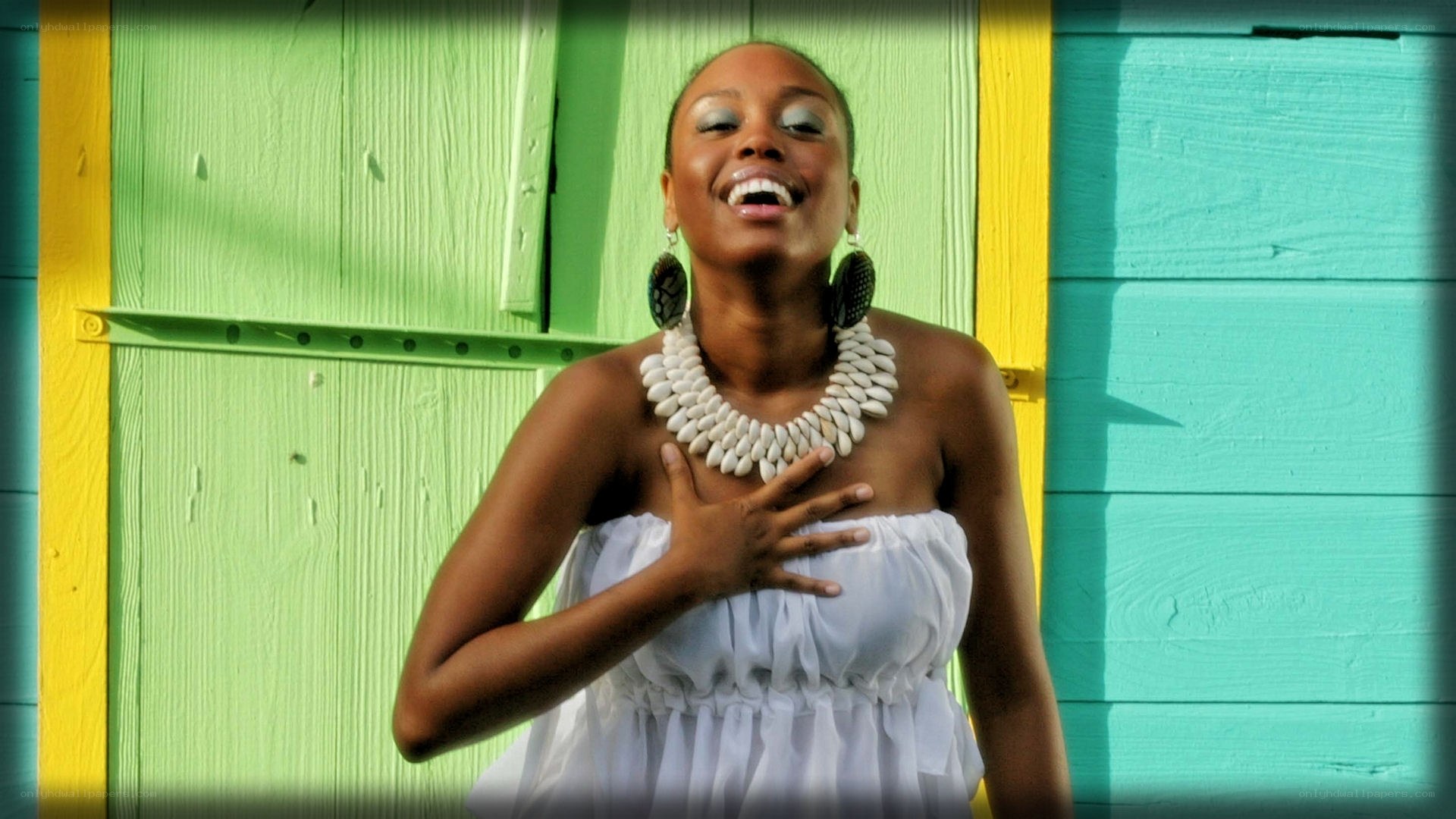 woman laughing in front of colorful wall
