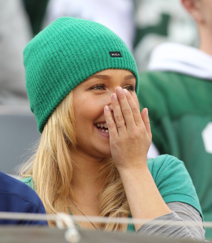 woman laughing in green beanie