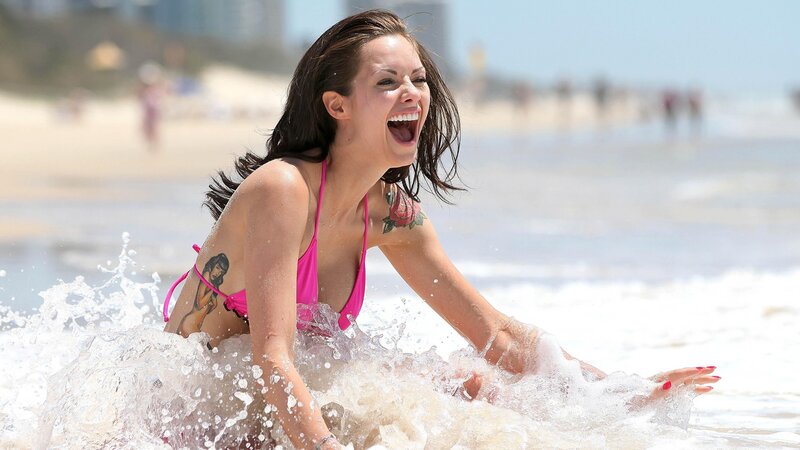 Woman laughing in ocean waves