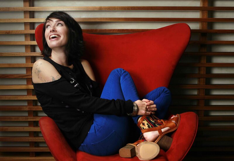Woman laughing in red chair