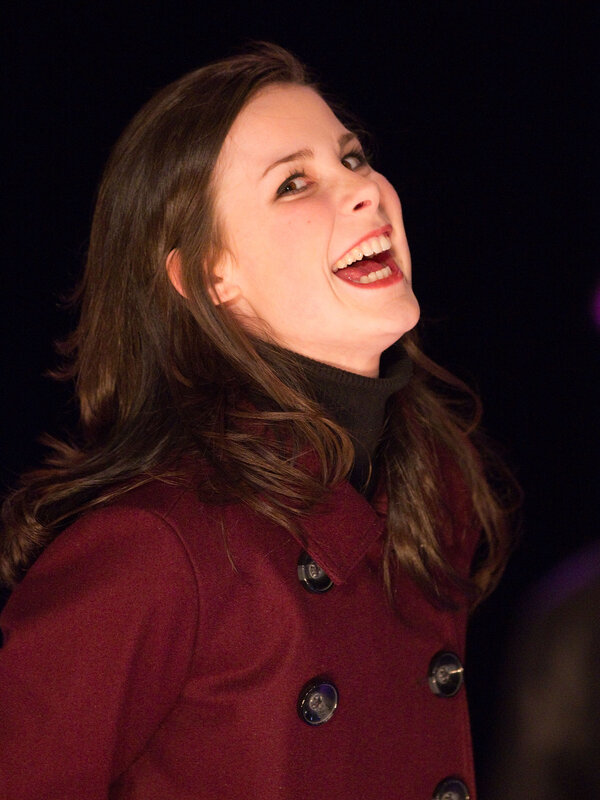woman laughing in red coat