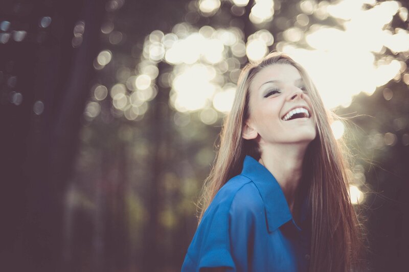 woman laughing in sunlight