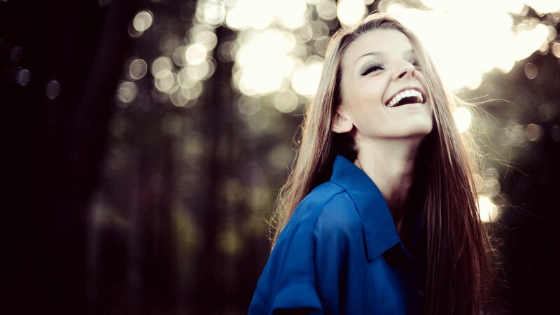 woman laughing in sunlight