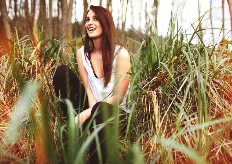 woman laughing in tall grass