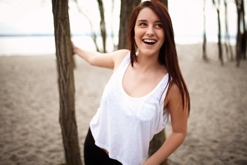 woman laughing on a beach