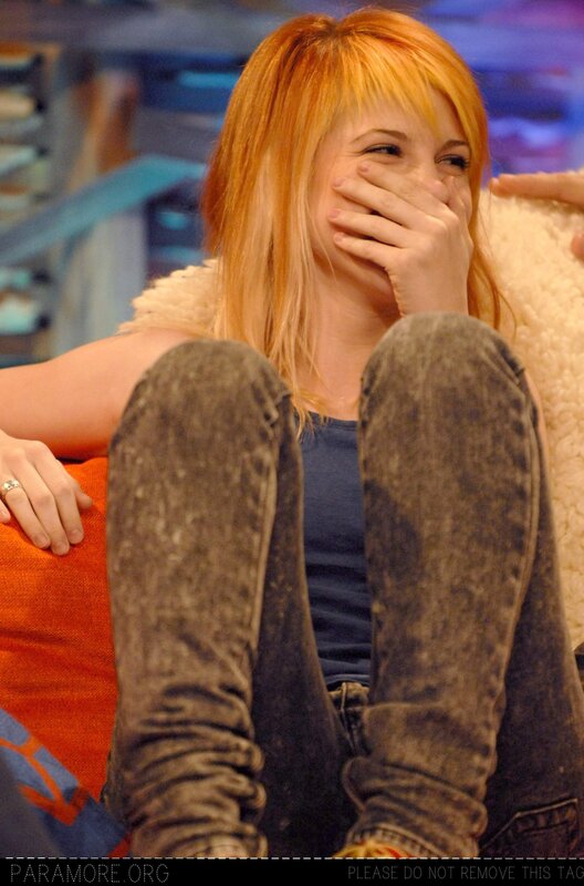woman laughing on a couch
