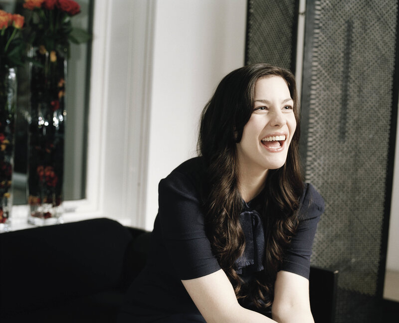 woman laughing on a couch