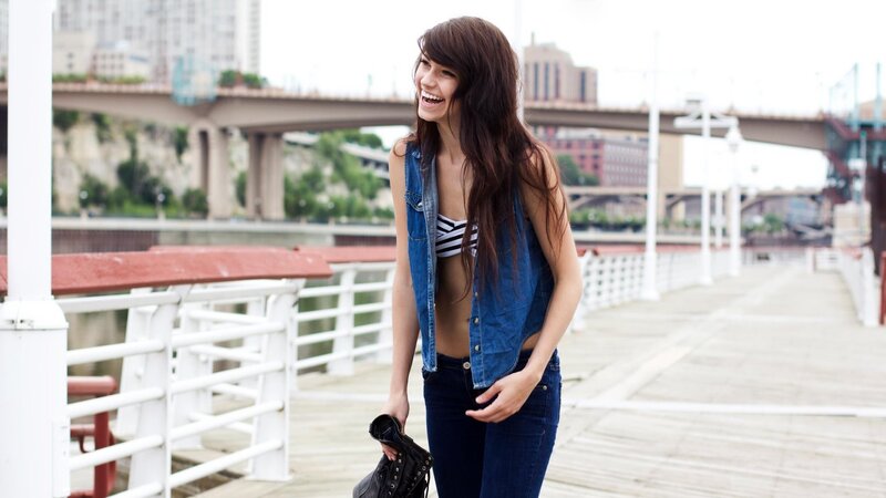 woman laughing on a pier