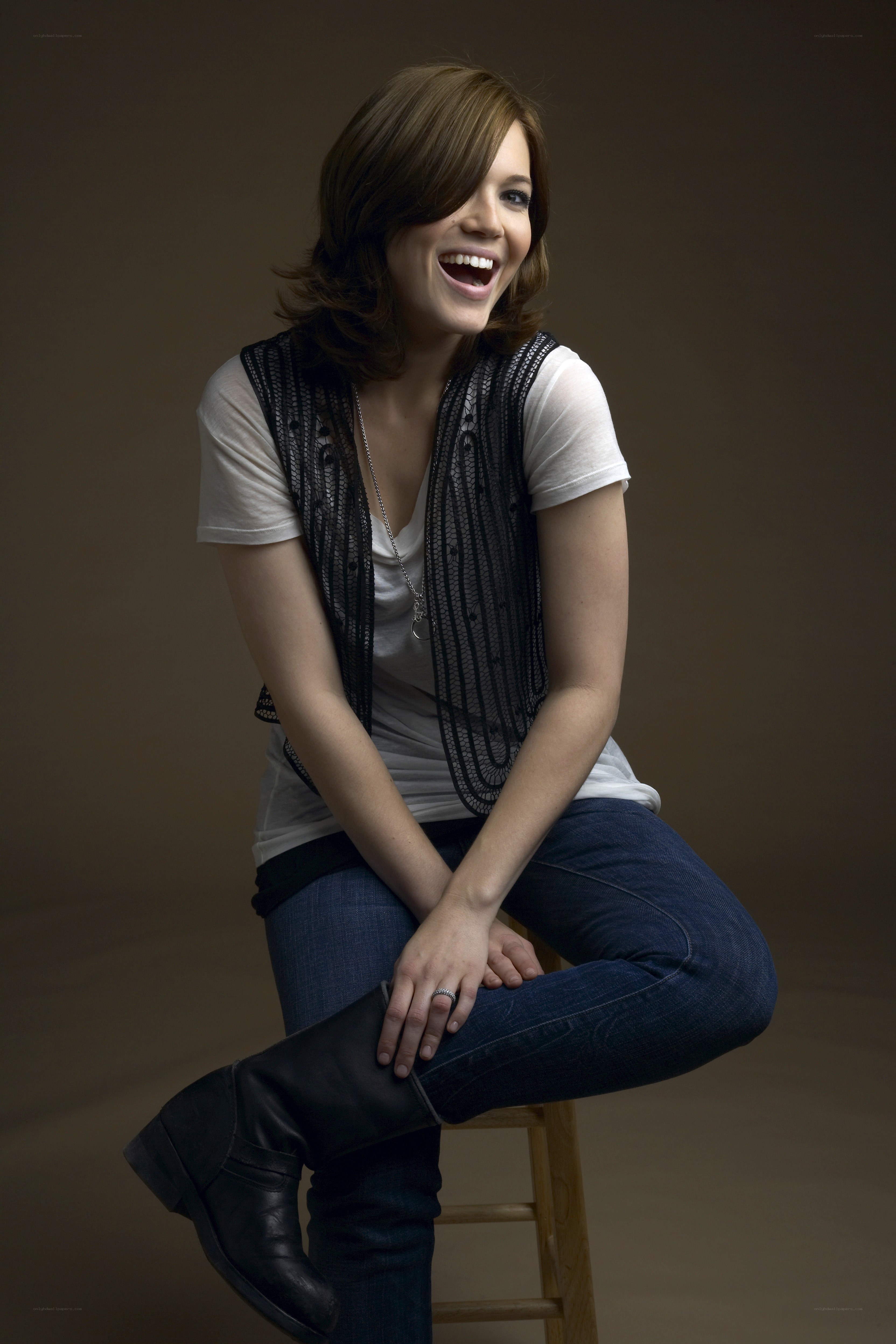woman laughing on a stool