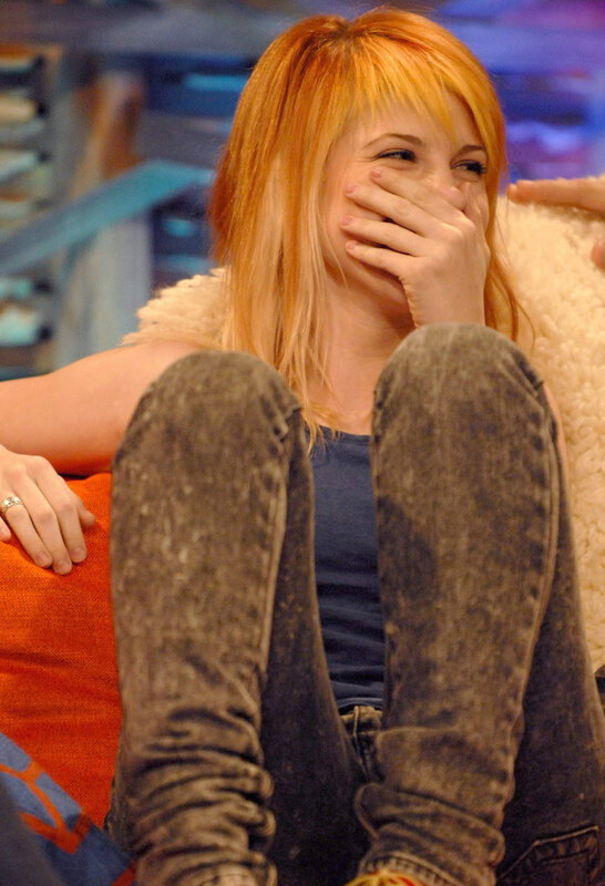 woman laughing on couch