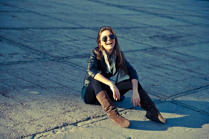 Woman laughing on pavement