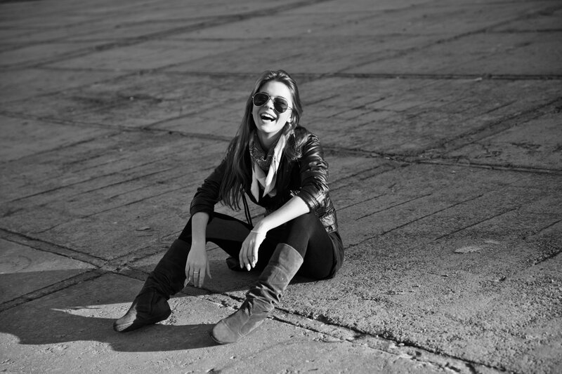 woman laughing on pavement