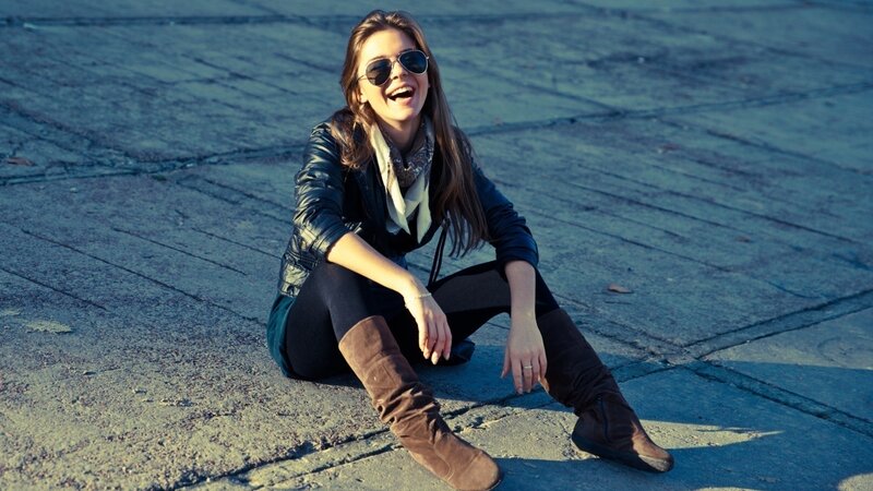 Woman laughing on pavement