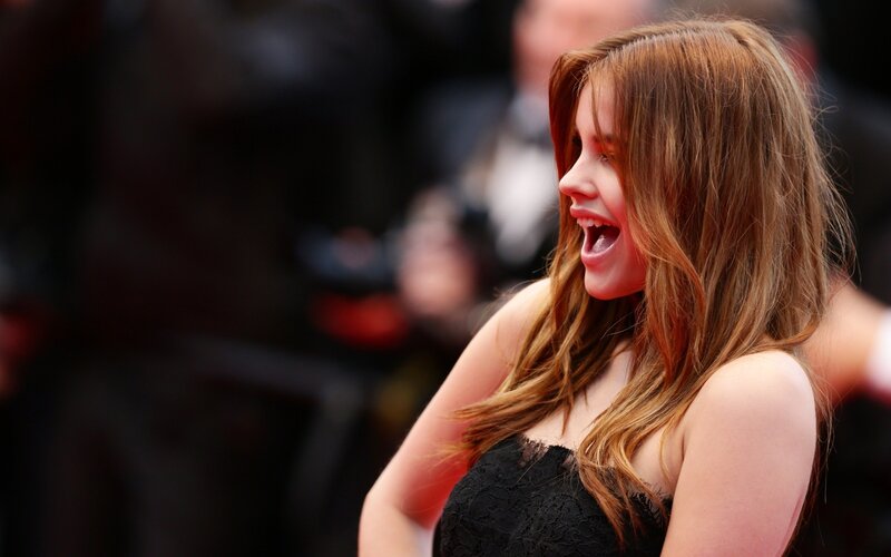 woman laughing on red carpet