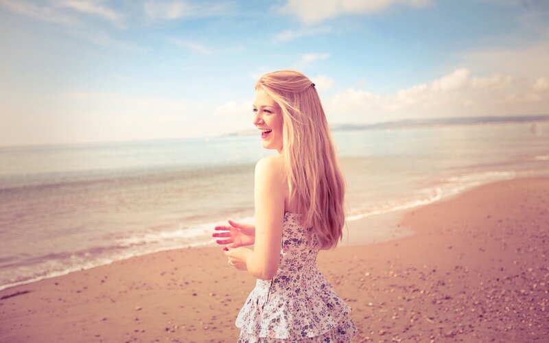 woman laughing on the beach