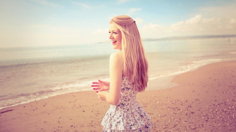 woman laughing on the beach