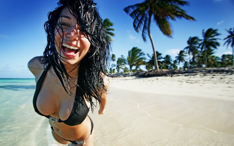 Woman laughing on tropical beach