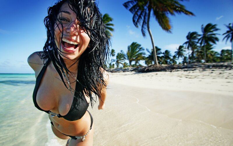 Woman laughing on tropical beach