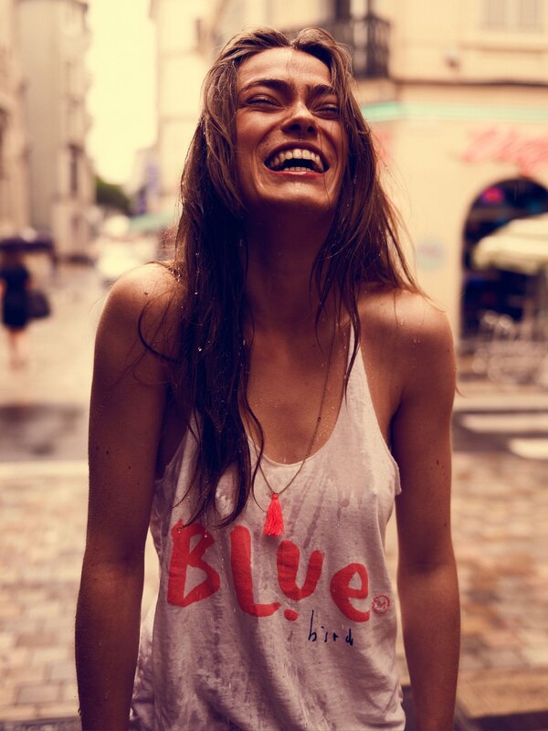 woman laughing on wet street