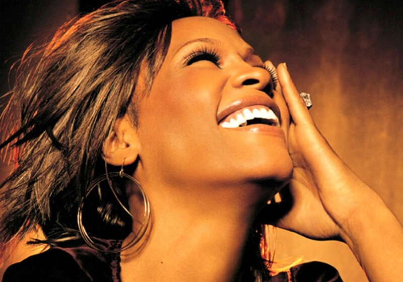 Woman Laughing with Hand on Face — Brown
