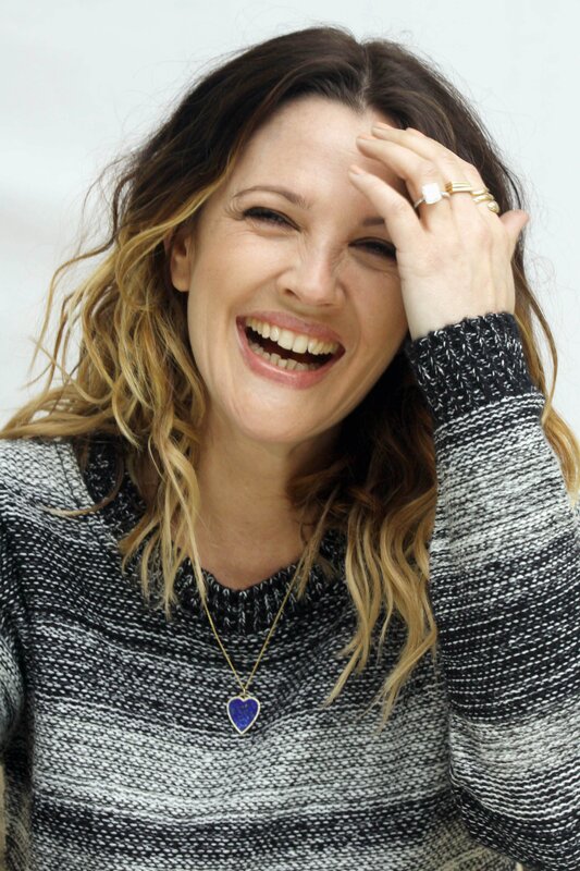 woman laughing with hand on head