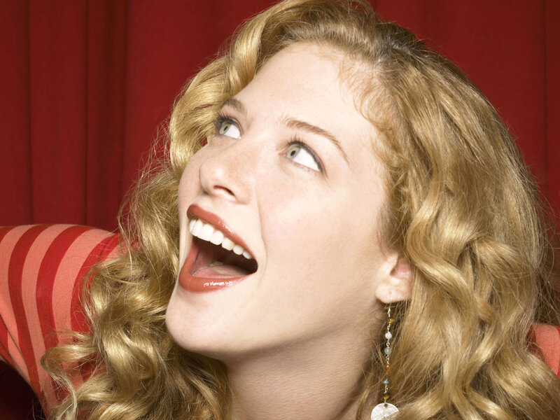 woman laughing with red background