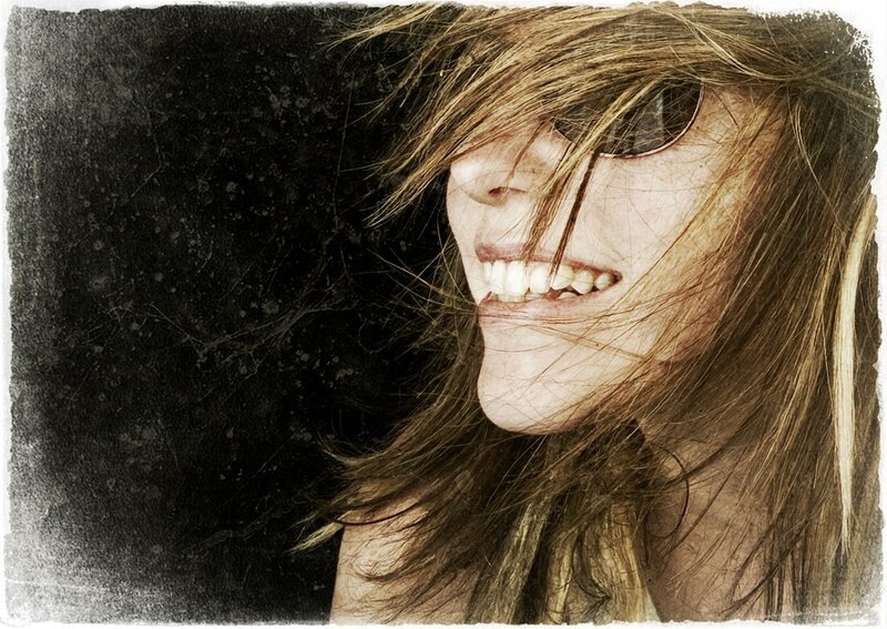 woman laughing with wind-blown hair