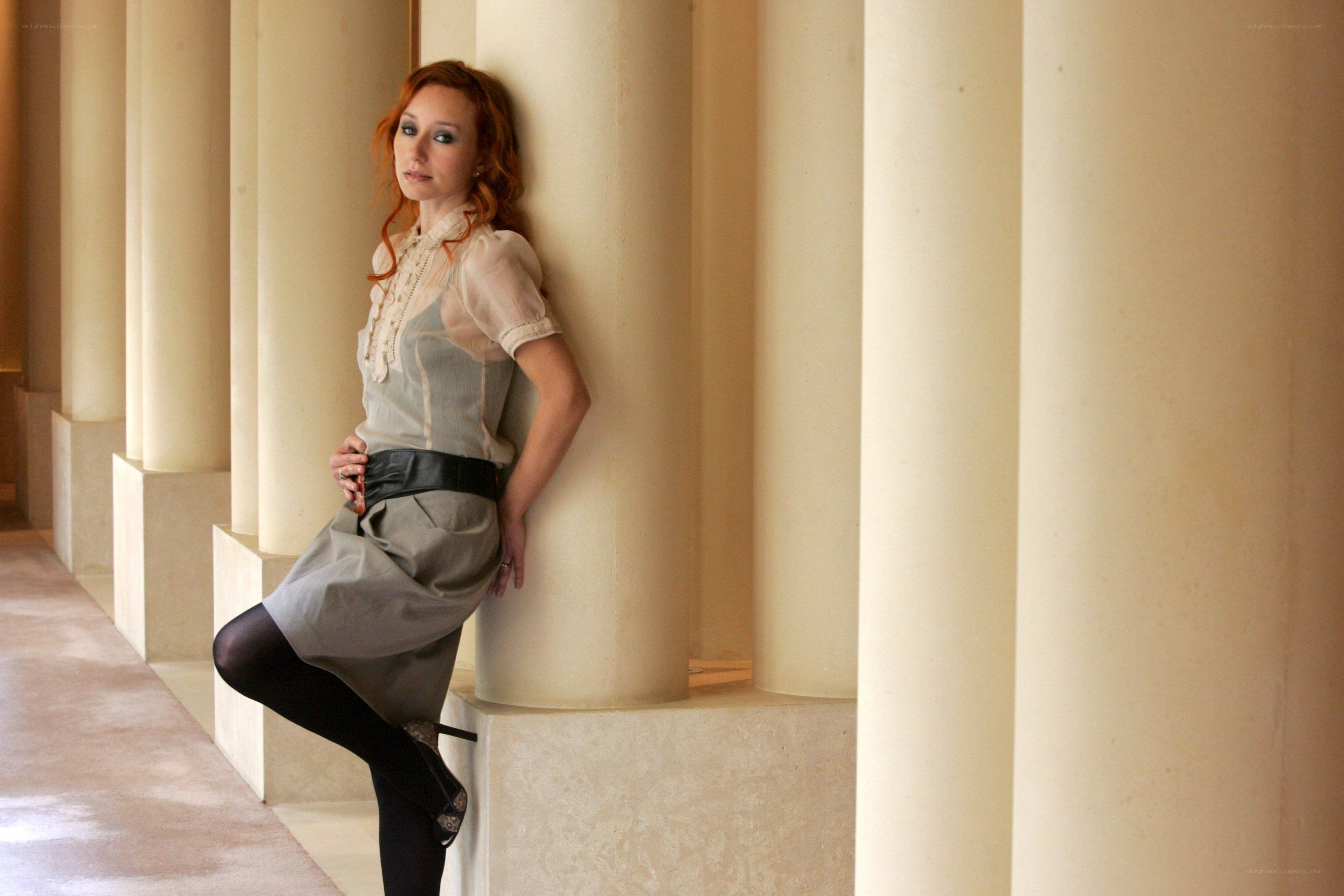 woman leaning against a column