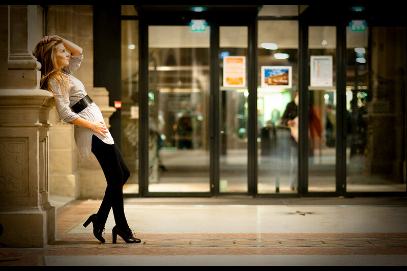 woman leaning against a pillar