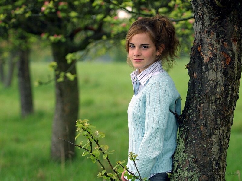 woman leaning against a tree