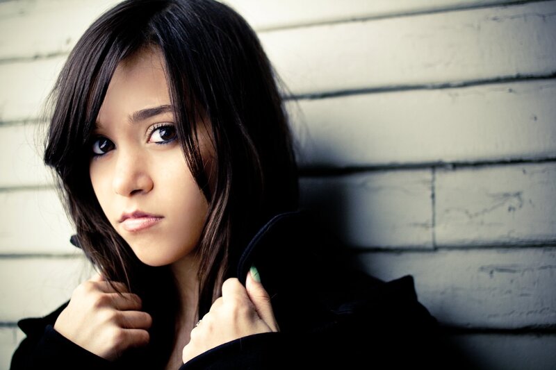woman leaning against a wall