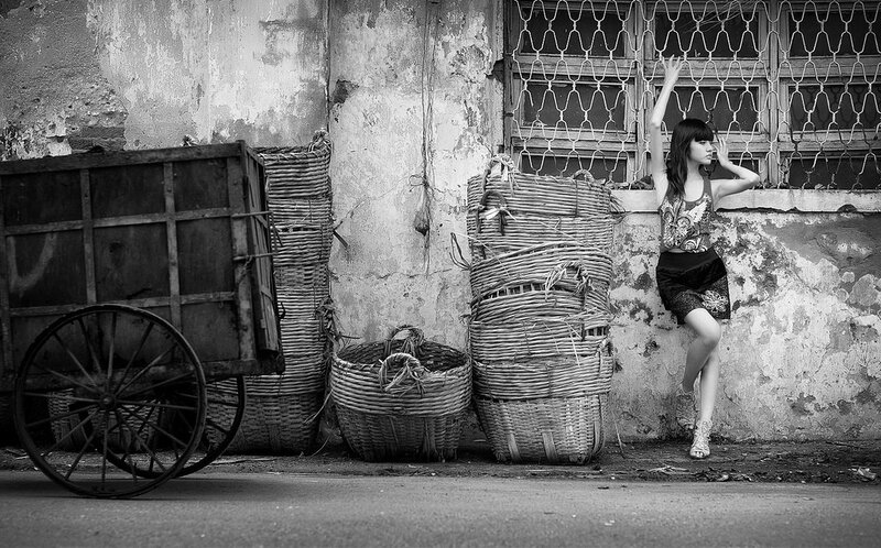 woman leaning against a wall