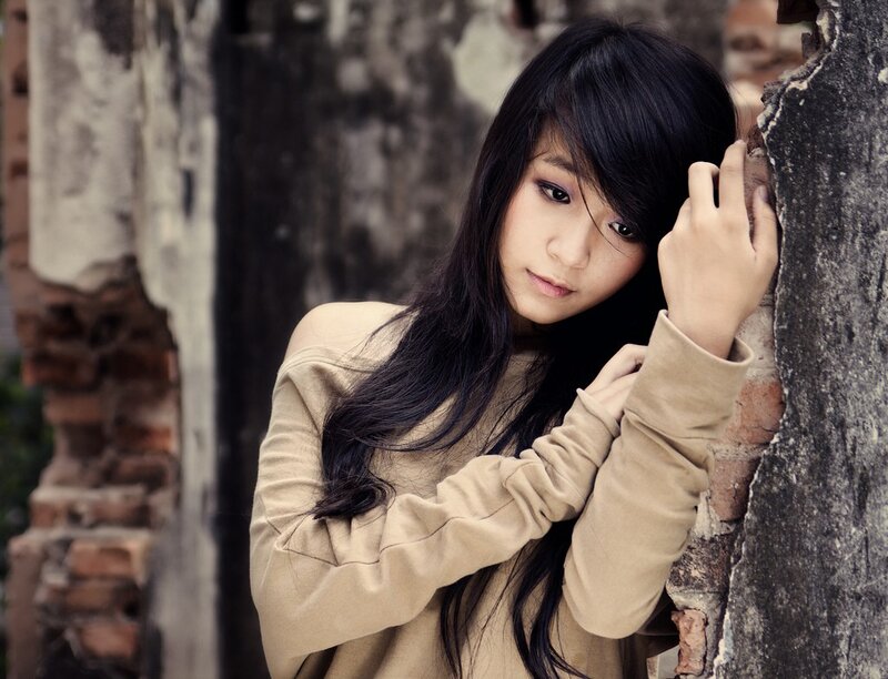 woman leaning against a wall