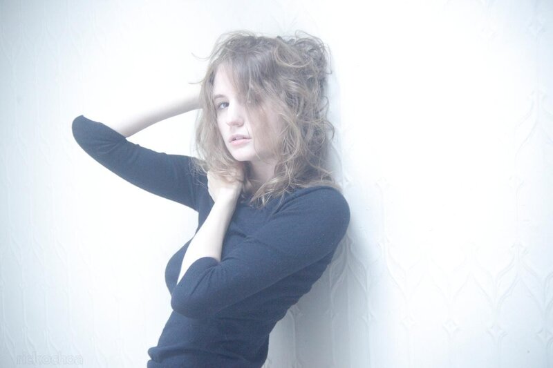 woman leaning against a wall