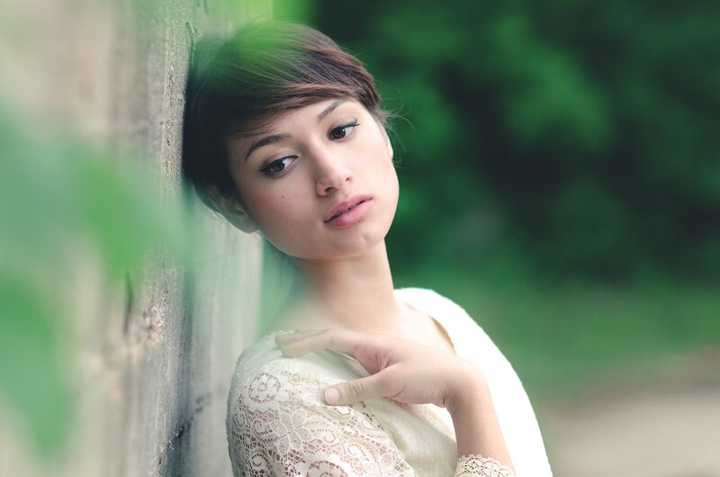 woman leaning against a wall