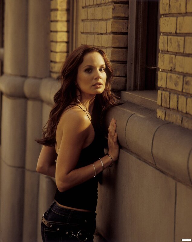 woman leaning against a wall
