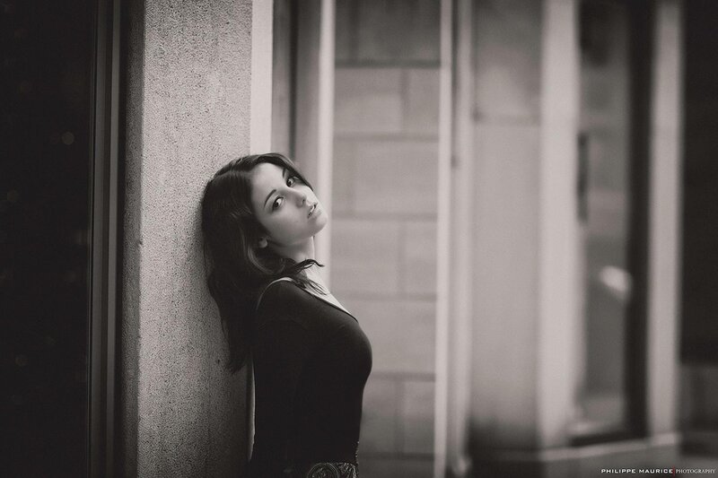 woman leaning against a wall