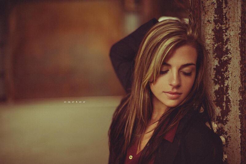 woman leaning against a wall