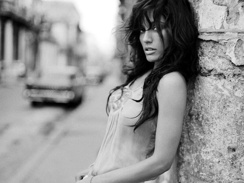 woman leaning against a wall