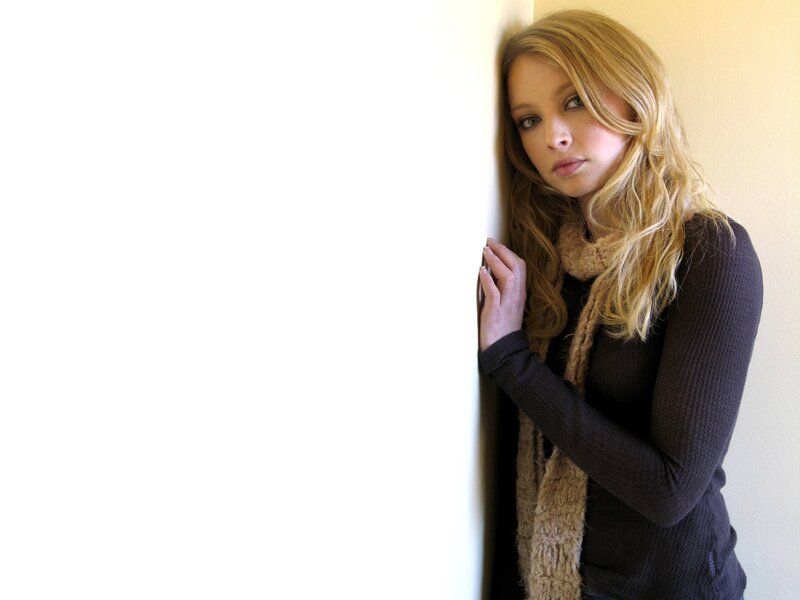 woman leaning against a wall