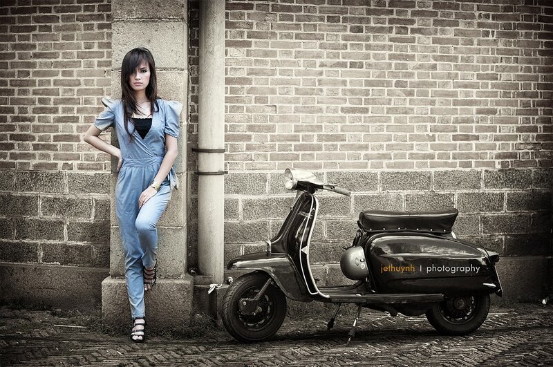 woman leaning against brick wall