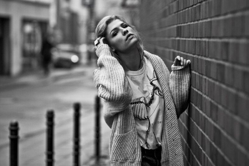 woman leaning against brick wall