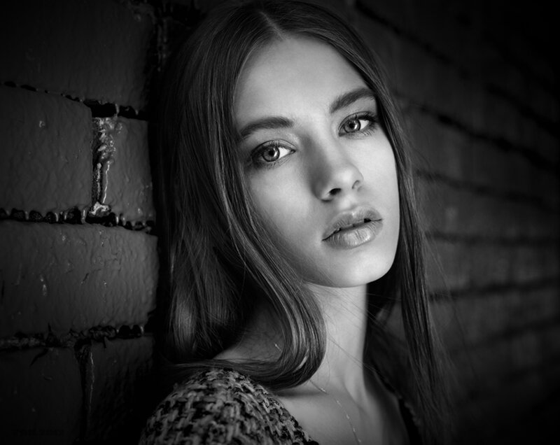 Woman Leaning Against Brick Wall — Black